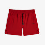 A front view of The Shorts in red, laid flat on a white background. The image highlights the elasticated waistband with a black drawstring, side pockets, notched hems, and the black c'est normal logo.