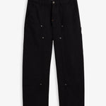 A front view of The Carpenter Pant in black, laid flat on a white background. The image highlights the double-knee panels, copper-toned rivets, slash pockets, and the embroidered c'est normal logo on the side seam.