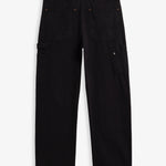 A back view of The Carpenter Pant in black, laid flat on a white background. The image highlights the two back pockets, a hammer loop, side leg pockets, and a c'est normal logo patch on the back right pocket.