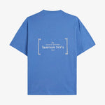 Le Linen T-Shirt in azure — back view showing the white C'est normal French Riviera Club logo