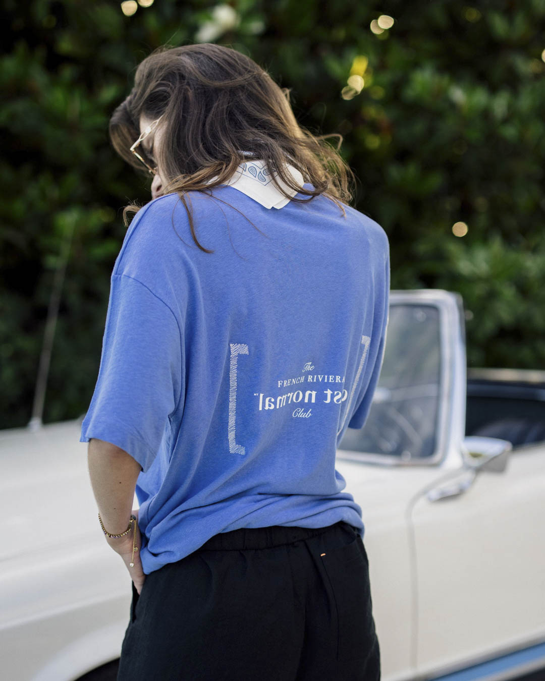 Le Linen T-Shirt in Azure — back view with French Riviera Club graphic by a classic car
