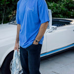 Le Linen T-Shirt in Azure — worn while standing next to a white vintage convertible