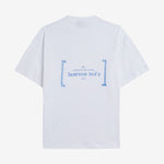 Le Linen T-Shirt in white — back view with blue C'est normal French Riviera Club graphic