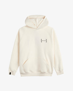 A front view of Le Hoodie in cream, laid flat on a white background. The image highlights the oversized fit, kangaroo front pocket, the FRC mirror logo on the chest, and the signature c'est normal cuff tag on the sleeve.