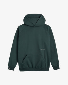 A front view of The Kangaroo Hoodie in pine, laid flat on a white background. The image highlights the hood with no drawstrings, the front kangaroo pocket, and the white c'est normal logo.