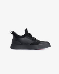 A side view of The Sneakers 2.0 in black, laid flat on a white background. The image highlights the tone on tone mesh upper, custom lace loops, rubber accents, and the slip-on design of the shoe.