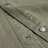 The Bilbao Overshirt in olive — close-up of the textured fabric and snap buttons