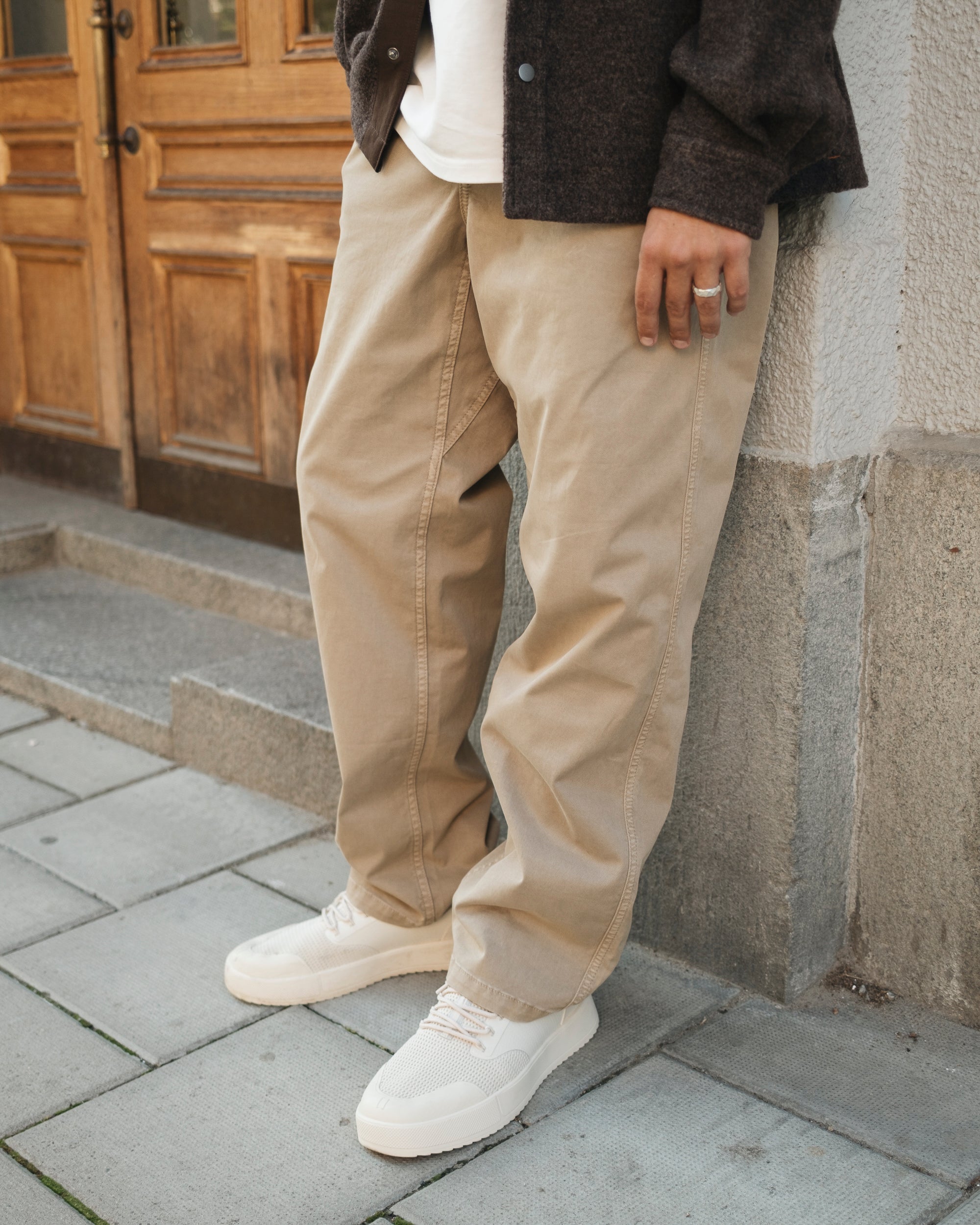 The Chamonix Chino in khaki beige — front lifestyle view worn with white sneakers