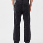 The Daily Cord Chino in anthracite grey — back view showing buttoned rear pockets