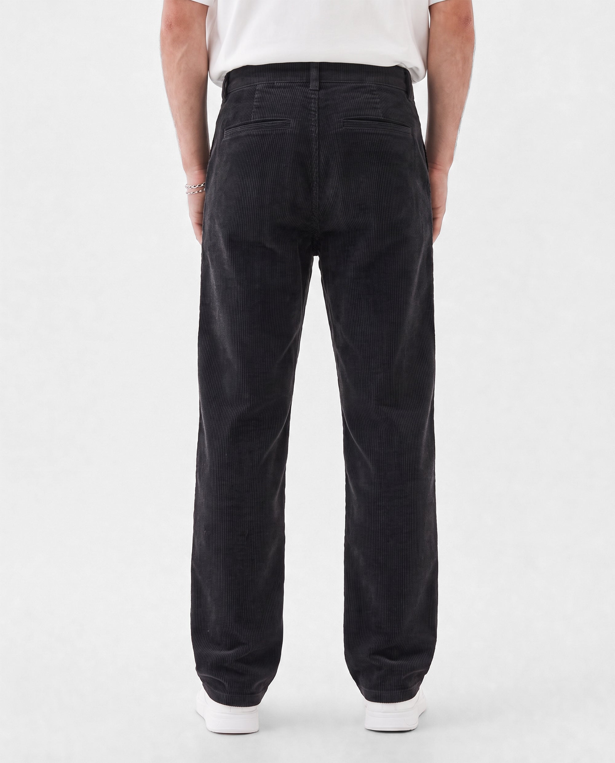 The Daily Cord Chino in anthracite grey — back view showing buttoned rear pockets