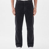 The Daily Cord Chino in anthracite grey — front model view wearing white sneakers