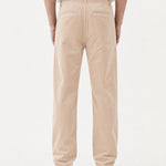 The Daily Cord Chino in Irish Cream — back view showing buttoned rear pockets