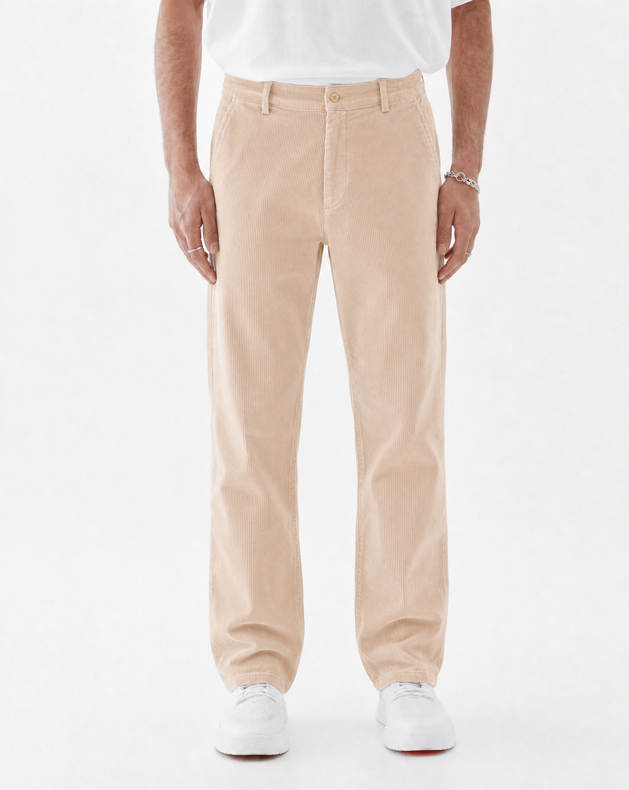 The Daily Cord Chino in irish cream — front view worn with a white t-shirt