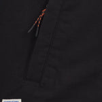 Denver Canvas Jacket in black — close-up of the zipper pocket and logo patch