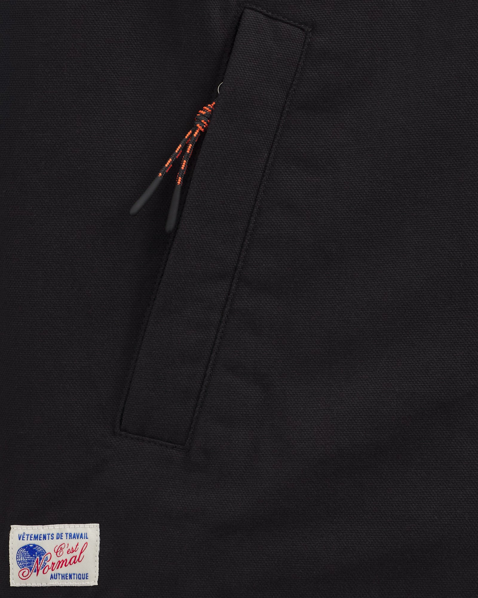 Denver Canvas Jacket in black — close-up of the zipper pocket and logo patch