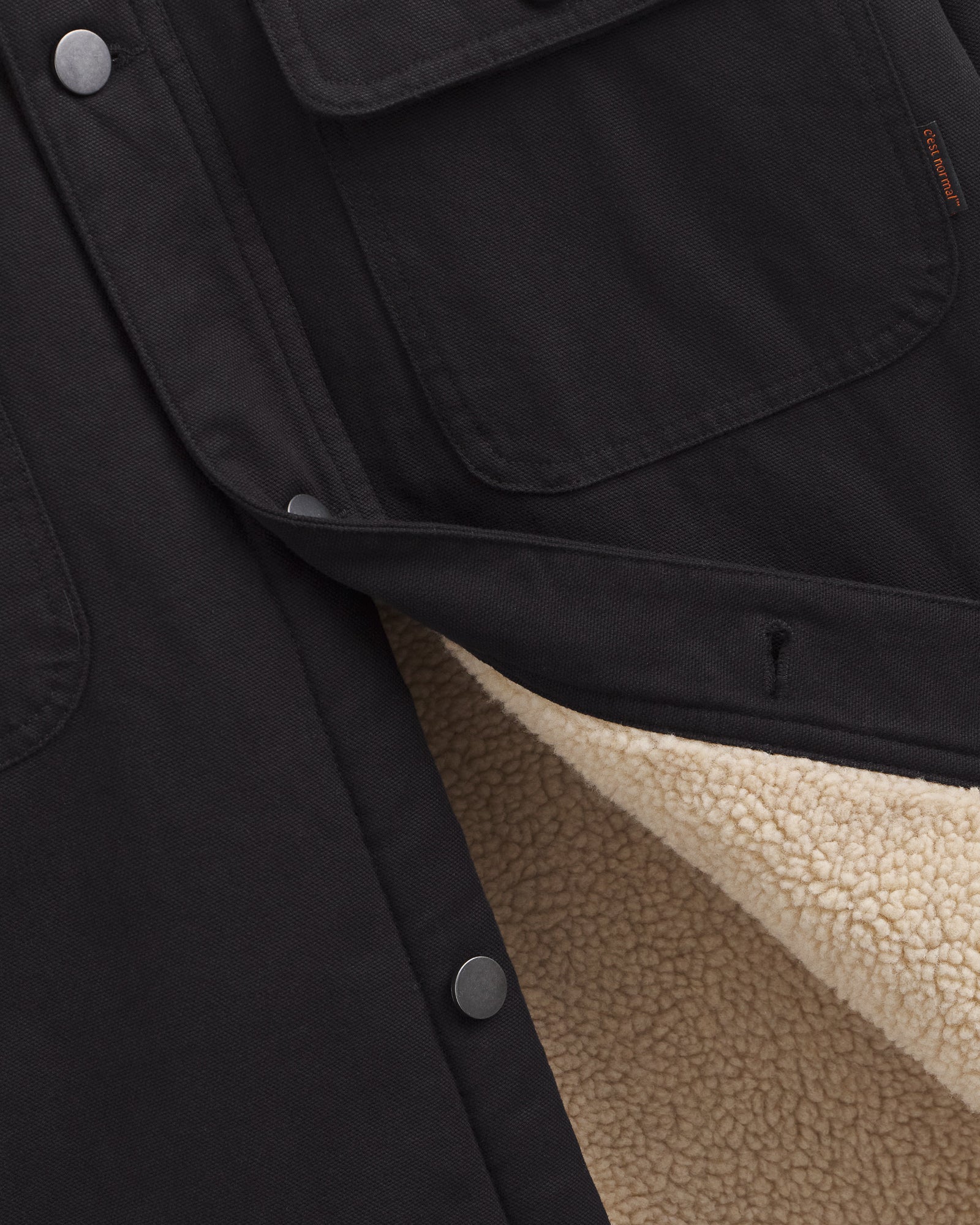 Denver Canvas Jacket in black — close-up of the canvas texture and fleece lining