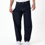 The Jeans Relaxed Straight Fit in rinse wash — pulled to show the stretchy fabric