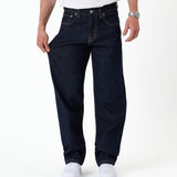The Jeans Relaxed Straight Fit in rinse wash — pulled to show the stretchy fabric