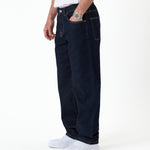 The Jeans Relaxed Straight Fit in rinse wash — side view with hand in pocket