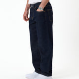 The Jeans Relaxed Straight Fit in rinse wash — side view with hand in pocket