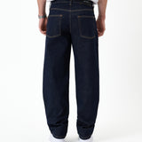 The Jeans Relaxed Straight Fit in rinse wash — back view with the black C'est normal rubber patch