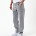 The Jeans Relaxed Straight Fit in light grey — worn with white sneakers