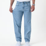The Jeans Relaxed Straight Fit in light blue — stretching the denim fabric to show flexibility