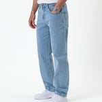 The Jeans Relaxed Straight Fit in light blue — worn with white sneakers