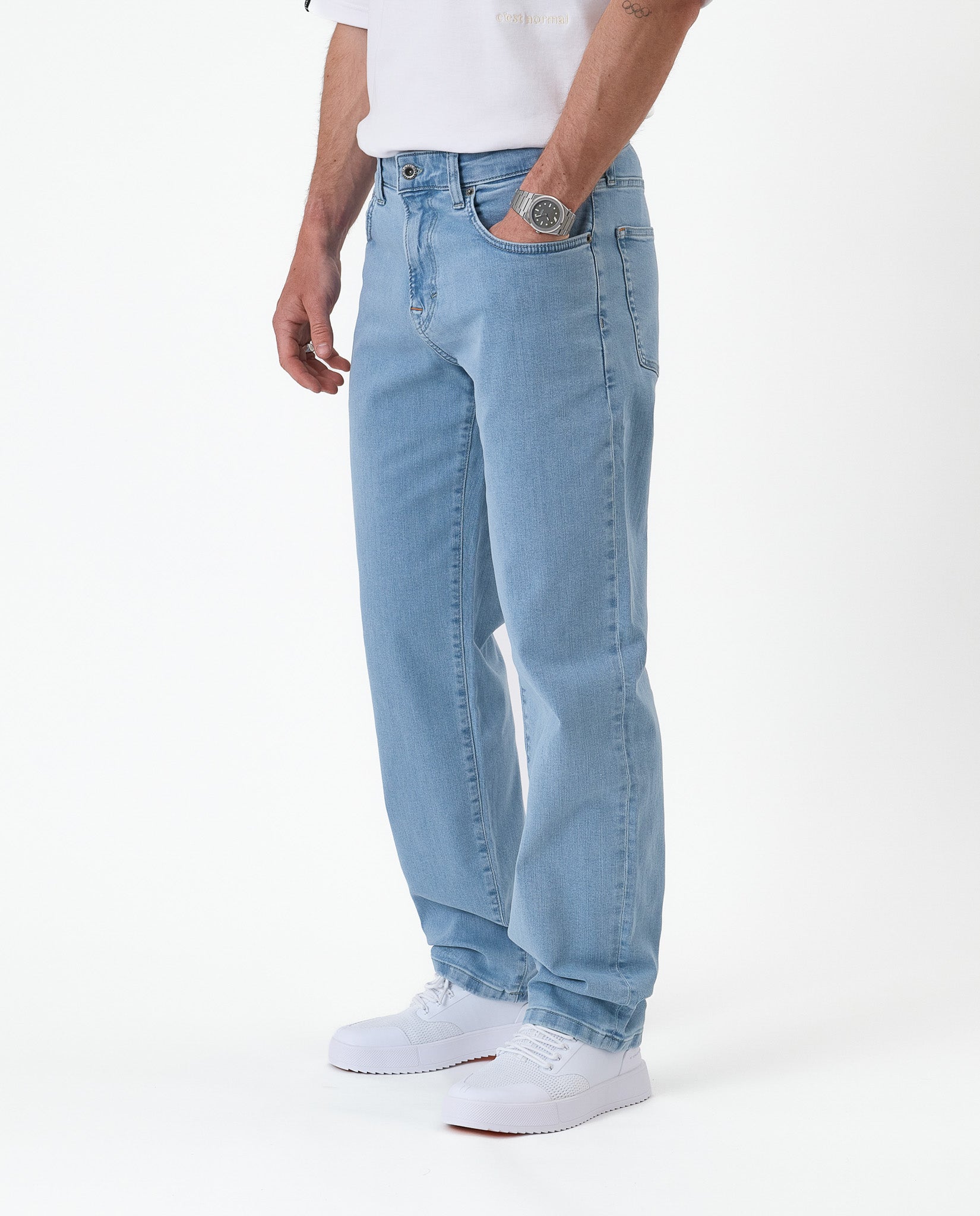 The Jeans Relaxed Straight Fit in light blue — worn with white sneakers