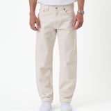 The Jeans Relaxed Straight Fit in ecru — front view worn with white sneakers