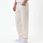 The Jeans Relaxed Straight Fit in ecru — side view worn with white sneakers