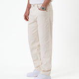 The Jeans Relaxed Straight Fit in ecru — side view worn with white sneakers