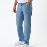 The Jeans Classic Straight Fit in light mid blue — side view worn with white sneakers