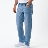 The Jeans Classic Straight Fit in light mid blue — side view worn with white sneakers