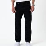 The Jeans Classic Straight Fit in Jet Black — front view worn with white sneakers