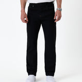 The Jeans Classic Straight Fit in Jet Black — front view worn with white sneakers