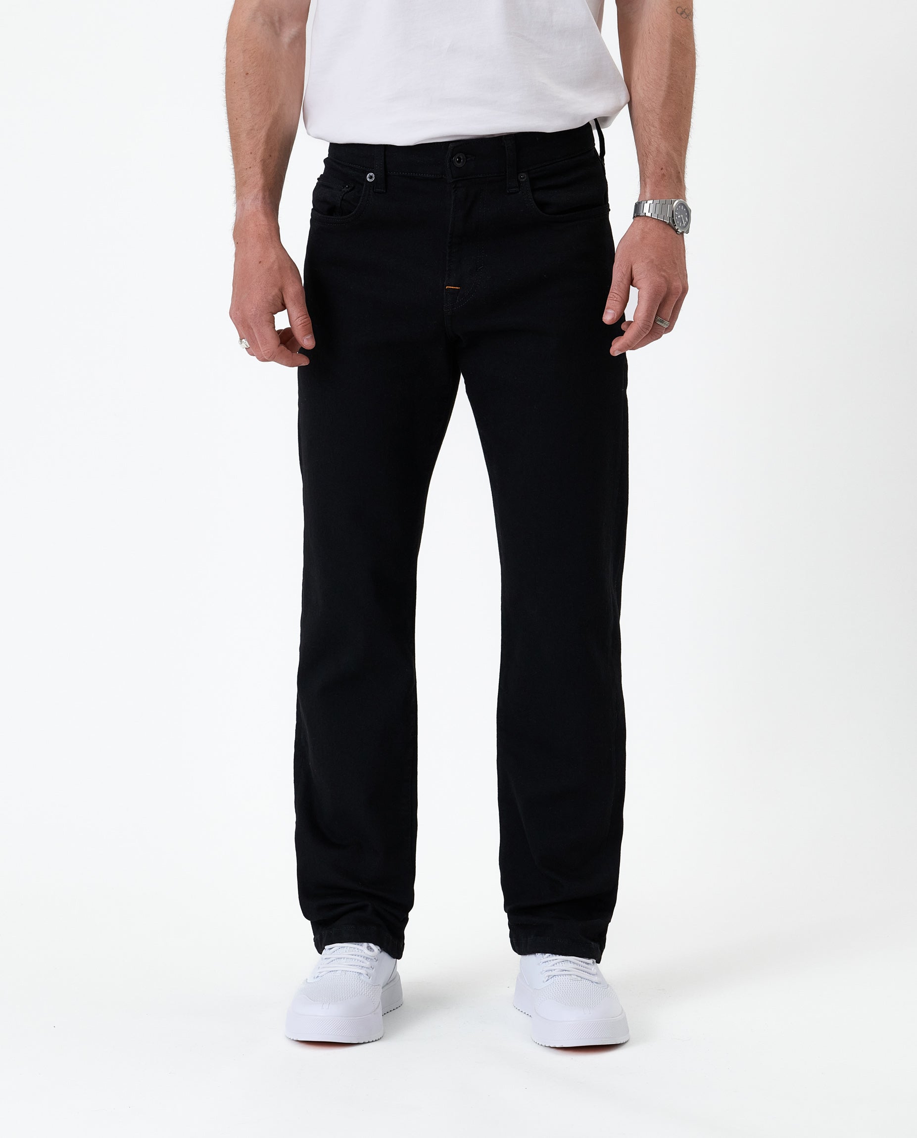 The Jeans Classic Straight Fit in Jet Black — front view worn with white sneakers