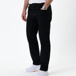 The Jeans Classic Straight Fit in jet black — front view worn with white sneakers