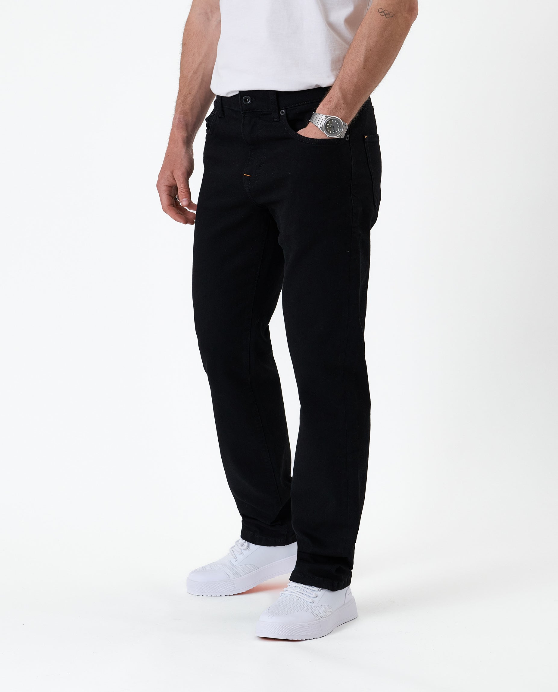 The Jeans Classic Straight Fit in jet black — front view worn with white sneakers