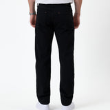 The Jeans Classic Straight Fit in Jet Black — back view worn with white sneakers