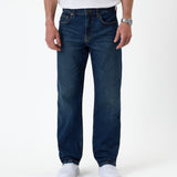 The Jeans Classic Straight Fit in Mid Wash Blue — front view on a model with white sneakers
