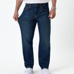 The Jeans Classic Straight Fit in mid wash blue — pulled at the thigh to show fabric stretch