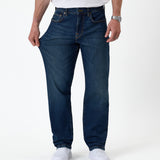 The Jeans Classic Straight Fit in mid wash blue — pulled at the thigh to show fabric stretch