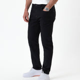 The Jeans Slim Fit in Jet Black — front view worn with white sneakers