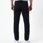 The Jeans Slim Fit in Jet Black — back view showing the slim silhouette