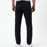 The Jeans Slim Fit in Jet Black — back view showing the slim silhouette