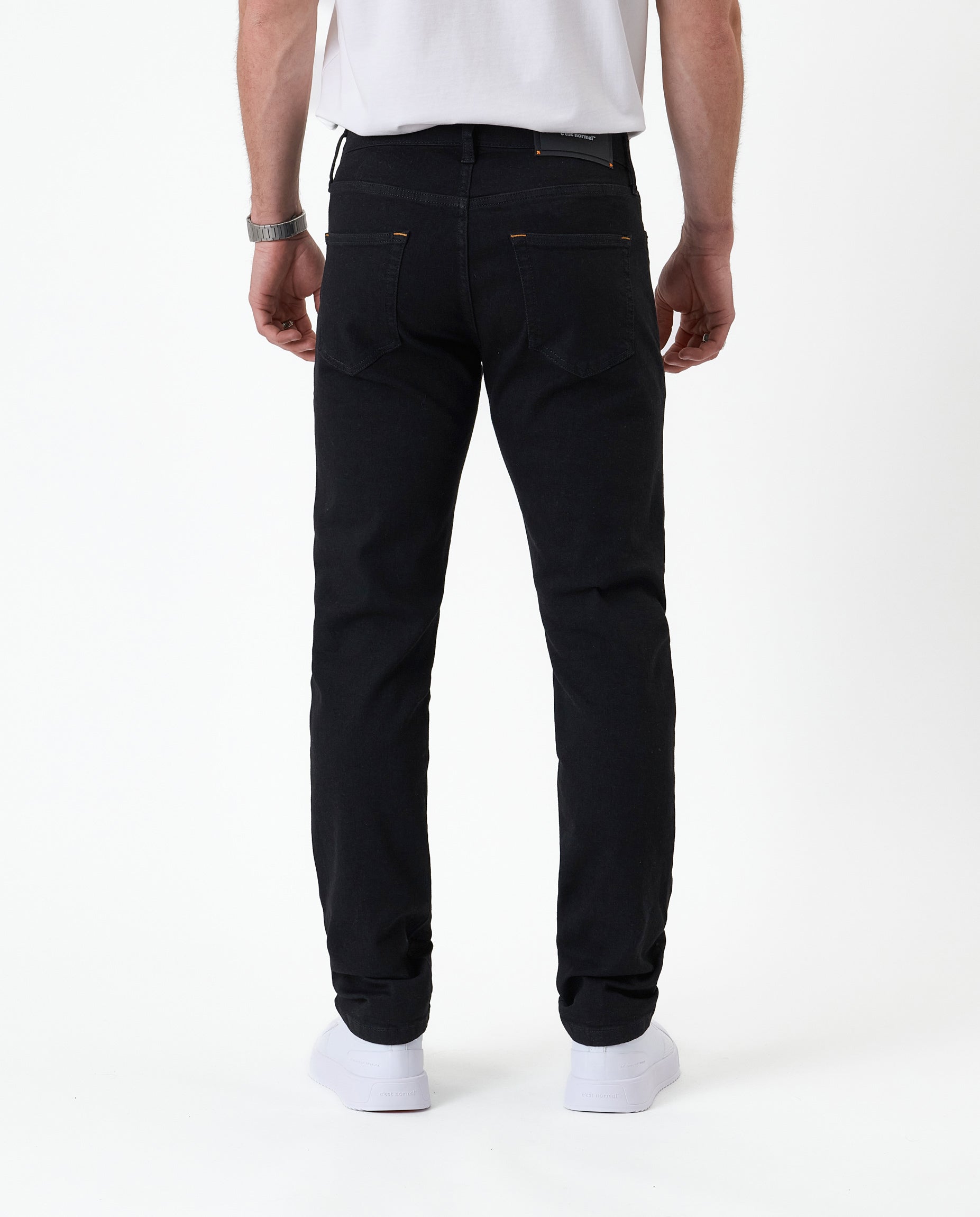 The Jeans Slim Fit in Jet Black — back view showing the slim silhouette