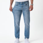 The Jeans Slim Fit in Light Midwash — showing the stretch of the Motion Fabric