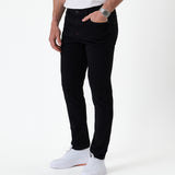 The Jeans Skinny Fit in Jet Black — worn with white sneakers