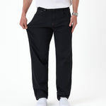 The Jeans Relaxed Straight Fit in jet black — demonstrating the stretch fabric at the thigh